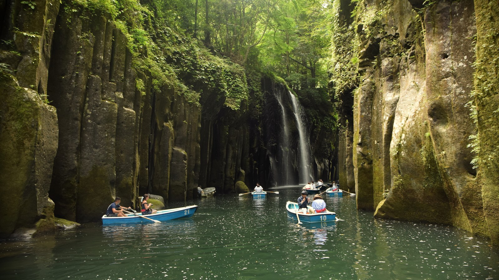 Rowboats on the Gokase River in Takachiho Gorge, Kyushu, with Manai Falls pouring down the basalt cliffs