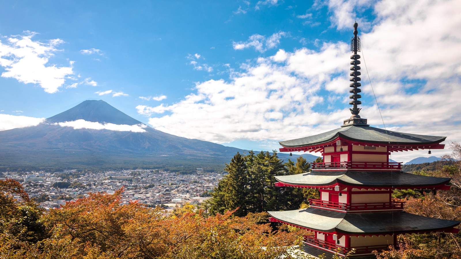 Chureito Pagoda framed by autumn trees with snow-dusted Mount Fuji behind, Japan